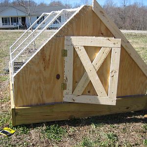 Here it is with part of the front complete. We wrapped the chicken wire under the trim boards to help anchor everything.