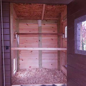 Inside of the coop, still a work in progress at this point. We have since added a poop board under the upper roosting bar (one of the best things we've done!) and bracket to hang a feeder below the poop board.