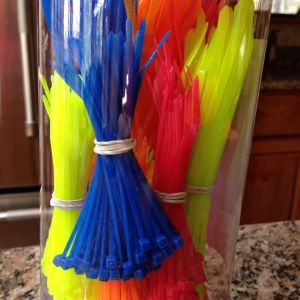 A bucket of zip ties of differing sizes in a variety of colors from Home Depot