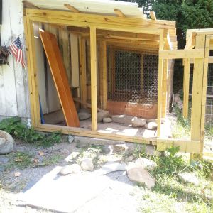 This small run, 5 x13 1/2 ft, is original square footage with the "barn" . The original builder/owner used  a stone foundation to keep predators from digging. He had hole in the foundation for posts and chicken wire. I have added a frame (and a roof.)