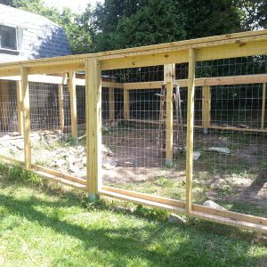 This is the extended 13 1/2 ft  x 16 ft with a 1 1/2 foot connection space.  The posts are set in place using metal post stakes.All of the frame is made with removeable panels to make any future modifications or removal easier. The whole run is made completley with screws and lag screws all predrilled.