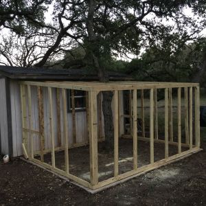 We placed all studs 2' on center; turning them on their edge.  We also left room on the far right corner to build the entry door for the run.  We also ended up framing through the rafters, around the tree to add increased strength and durability for the roof.