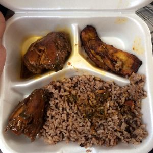 Traditional lunch of stewed chicken, rice and beans, and fried plantains.