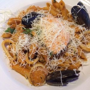 Penne mariscos. Pasta with mussels, clams, shrimp, salmon, and calamari.