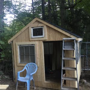 It's coming along.  This is the people door and the west facing side of the coop.  I built this whole thing around the little window in the peak.