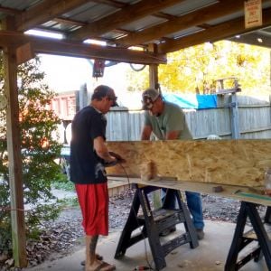 Dad and Son working on the bigger and better coop, hen house.