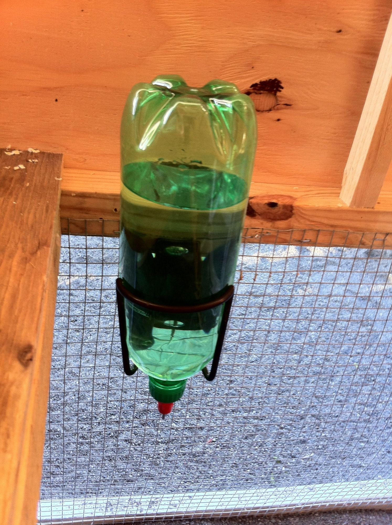 Bicycle water bottle bracket works perfect for a smaller 
coop style waterer. 

Gotta love the chicken nipples.

So easy and the girls love em ! 

Drill a small hole in top of bottle to vent air-lock.