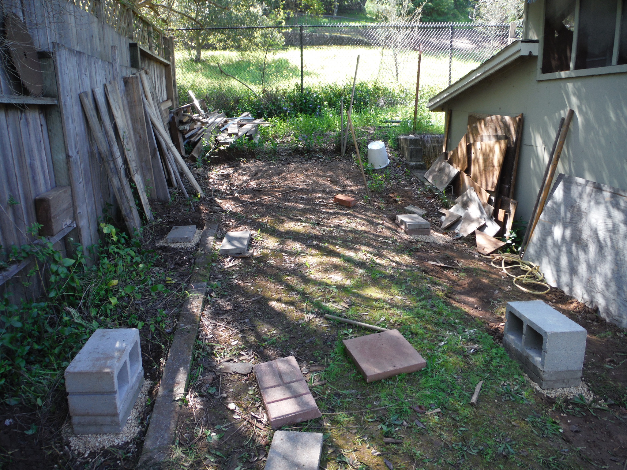 Clearing the area and getting started on the leveling of the cinder blocks.