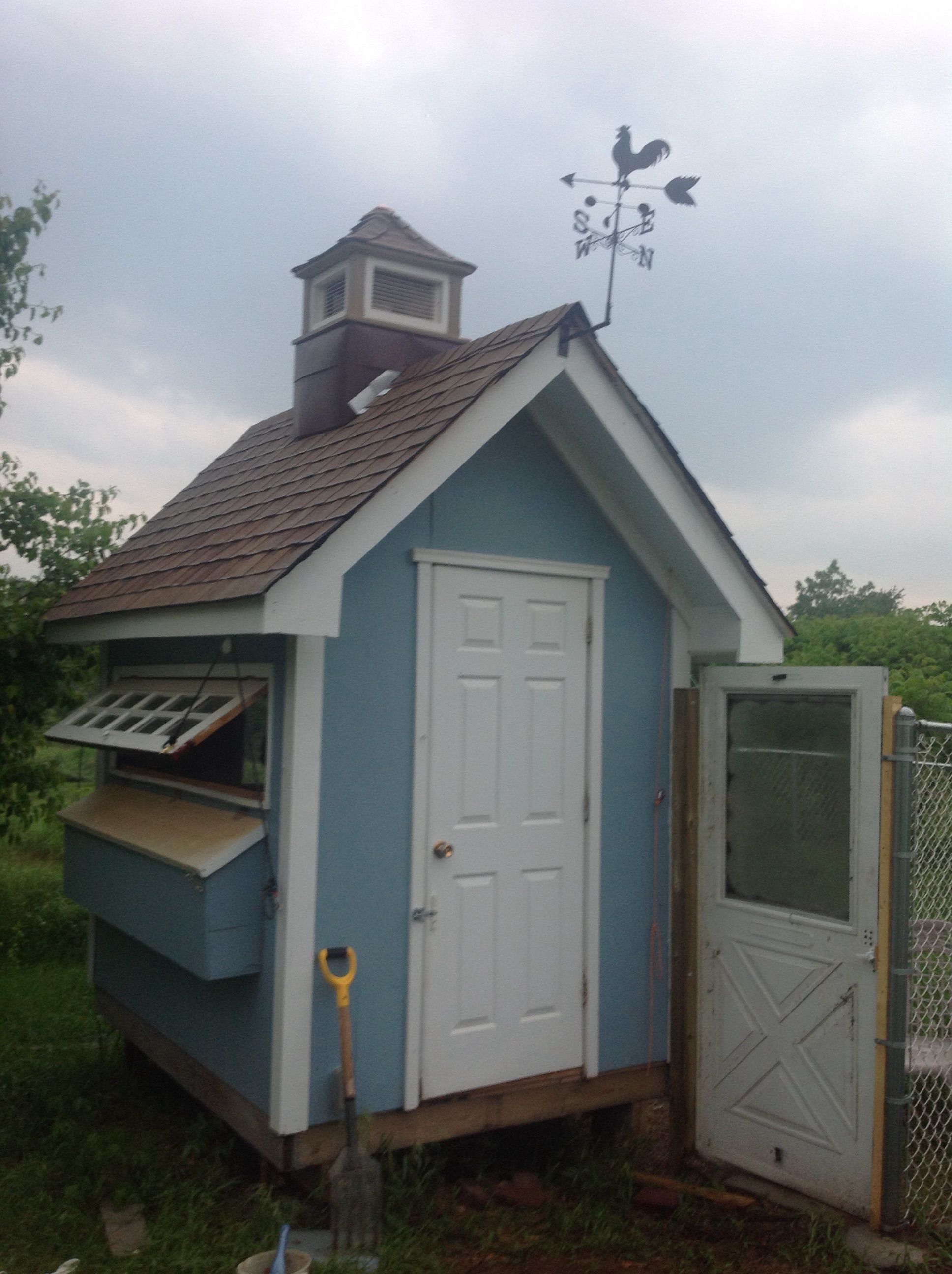 Final touch on the coop with a weather vane. Started the run with an old screen door and used chain link fencing.
