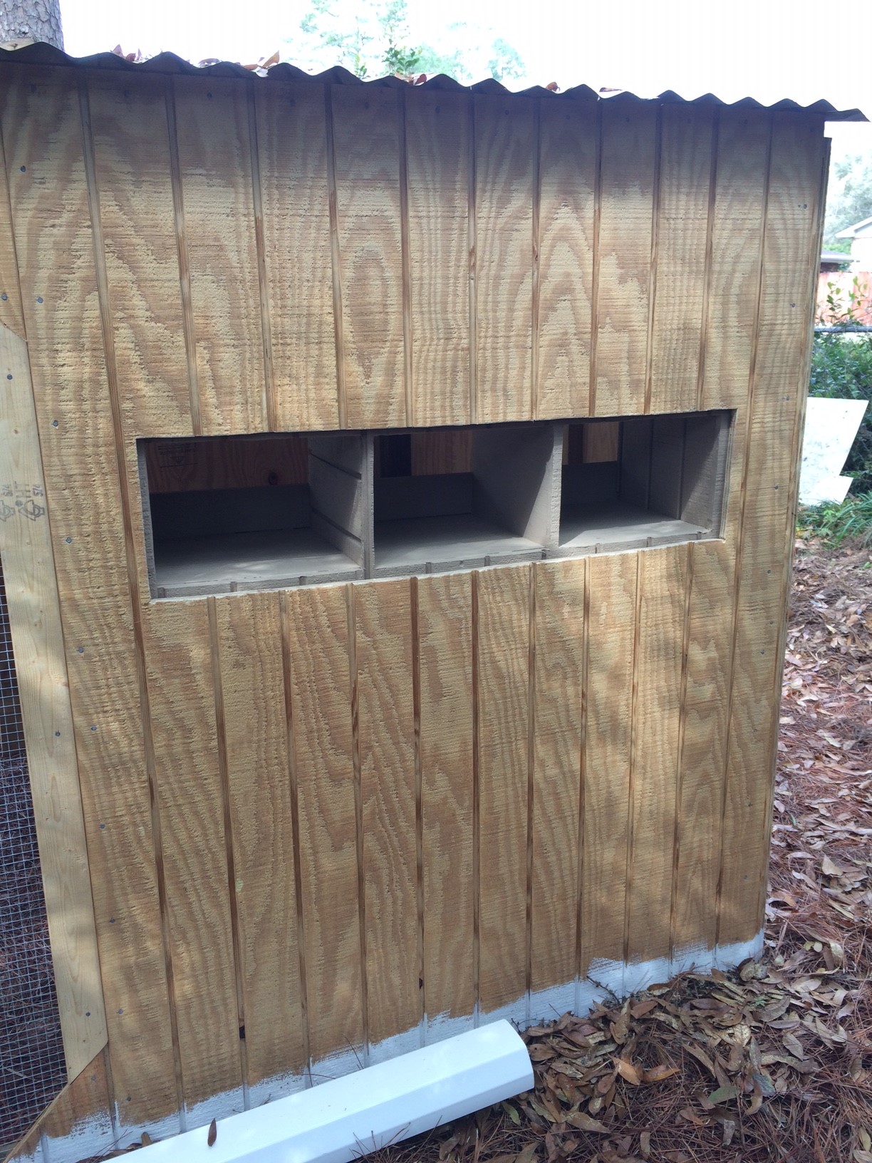 Nesting boxes were set in place inside, and holes cut in the wall to create access from the outside.