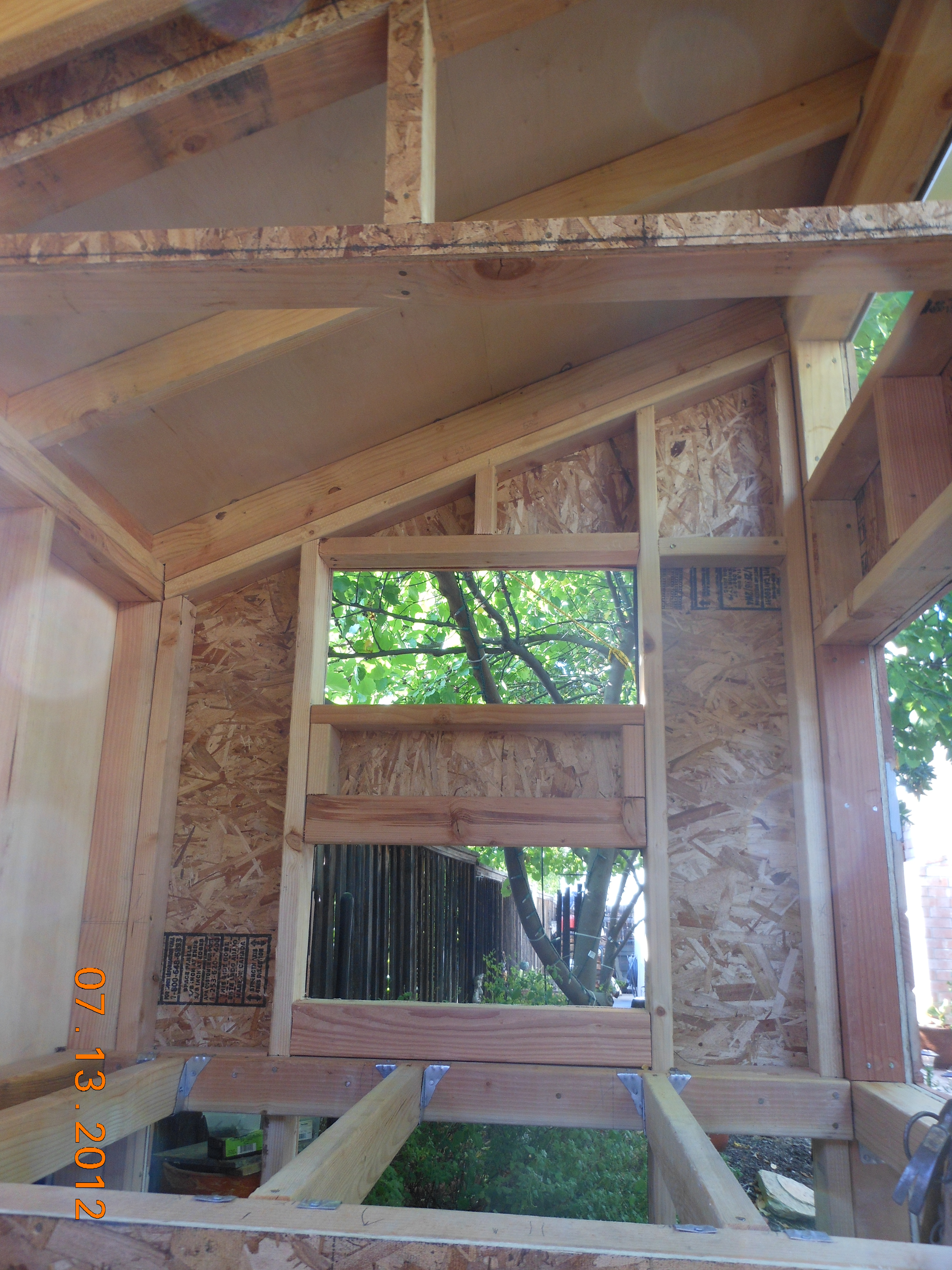 This is the inside of the coop.  Your looking at the nesting box (bottom) and vent.  There will be two large doors.  One on the inside of the run, and one where I'm taking the picture. The inside of the coop will also be insulated.