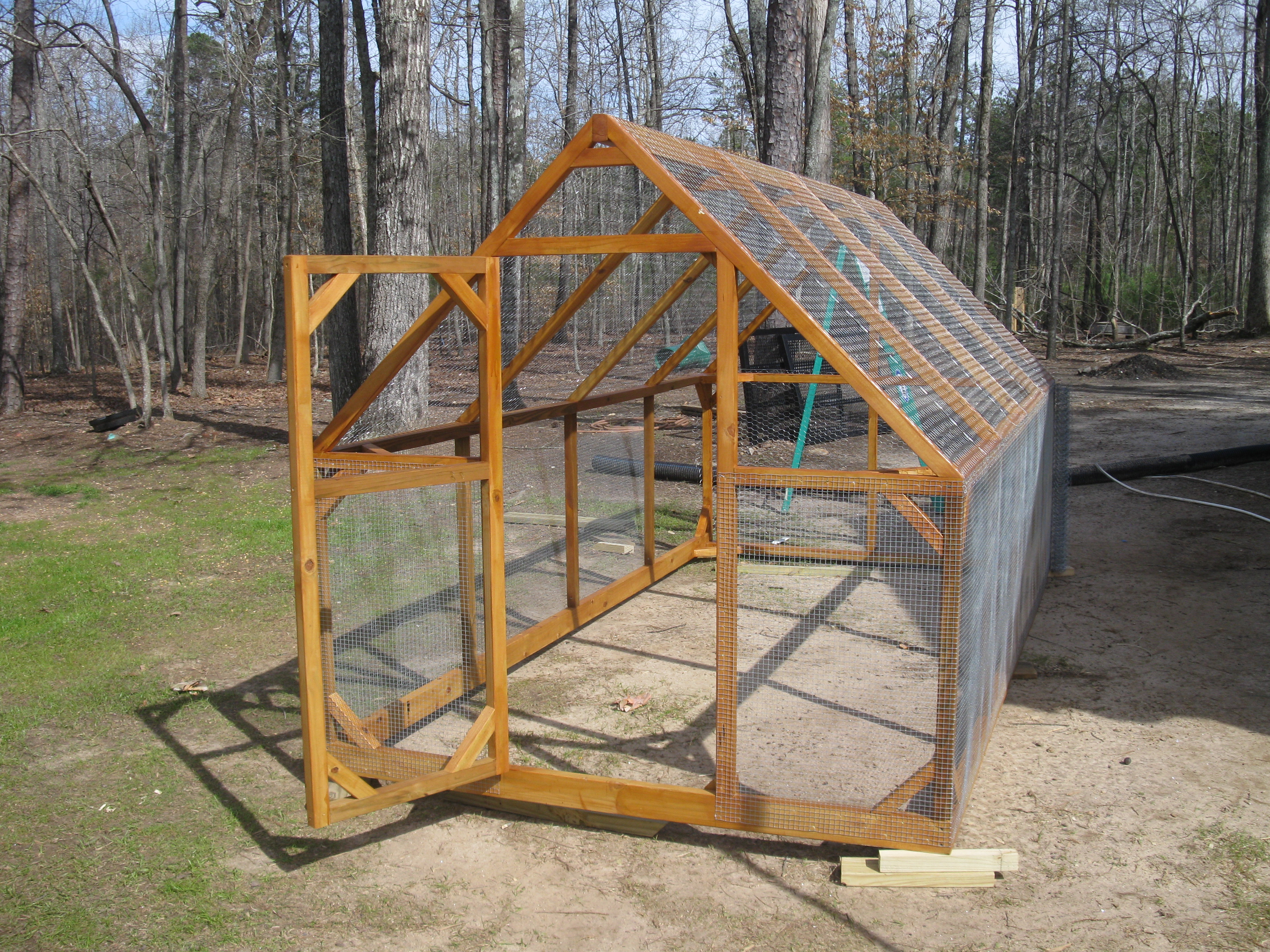 This run is 6' X 12' and 6' high in the center.  Made of treated 2x2's with 2x4's for the ridge board and base boards.  I used 1/2" hardware cloth for the lower section and 1" chicken wire for everything else.  Two people can move this without any problem. I used an air stapler (used for installing wood trim) to attach the wire to the framing.  Used spring hinges on the door.