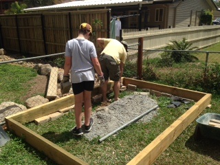 Us putting bricks in the gaps as our yard is slanted or sloped.