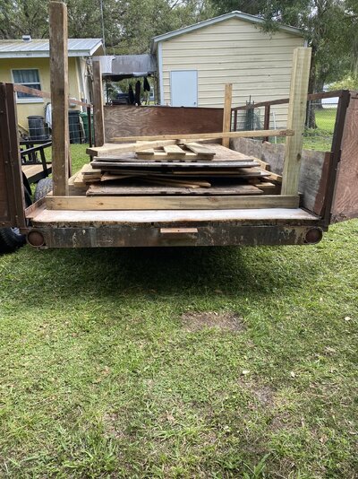 coop frame and extra reamiang wood in trailer.jpeg