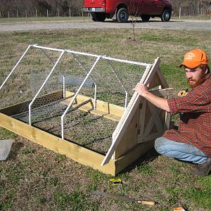 My husband hard at work. From this view you can see the pipe fittings that stabilize the sides.