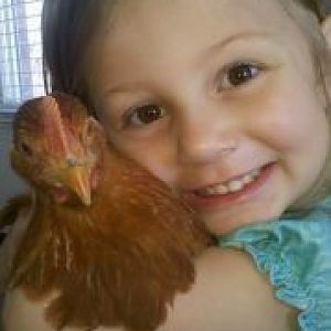 My Daughter and one of our New Hampshire Hens!