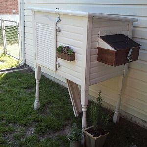 Stilts, the beginnigs of their ladder, white paint, a window box fashioned from a vintage box(filled with Hens and Chicks, of course!!) and a door from a medicine cabinet. All complete with latched and locks that will keep any preditor away!