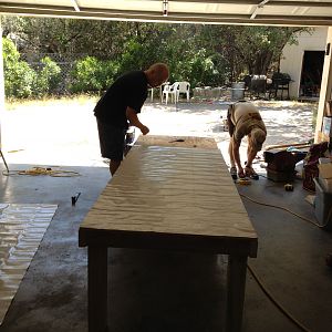 Dad and Dan adding lineolum tile to the plywood