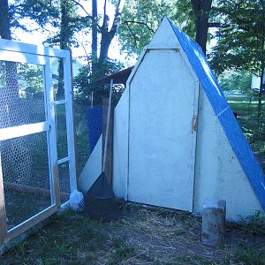 This is the back of the coop where the 'people doors' are.  A big thanks to my hubby for figuring out how to make the one for the coop as I wanted a backdoor like UrbanMama's coop but needed it to be tall enough for the guys in the house to walk into. The screened in part was the run we had on their old, small, store bought coop.  I am working on converting this into an arbor.  All parts of the coop need more paint as we ran out of each of the colors.