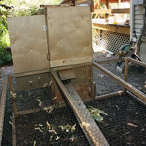 The pen is 6' x 6'.  The interior is approximately 2' high.  It is assembled with 2" x 2" beams and chicken wire.  The floor of the pen is open.  The swinging gate is removed and the pen is pressed against the cabinet.