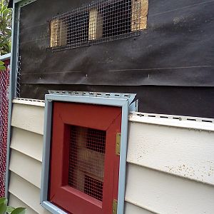 Being in Florida, its HOT and HUMID, so we put a nice 18" vent in high up to keep airflow in the coop so they don't get too hot. We used leftover shingles for the roof, so it does heat up a bit, but the open trap door, the two access doors and the vent make for a good bit of air circulation and keeps the coop reasonably cool. Here you can see the Egg Door where the boxes can be harvested without too much visibility from the chickens.