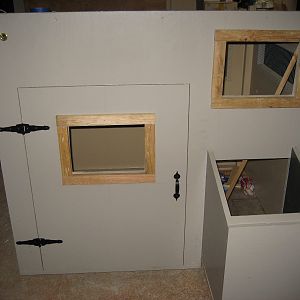 Door installed, nest box installed. I also decided that I wanted some windows in the front of the coop so that I could peek at the chickens.