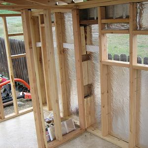 The interior wall separates the coop part from the food & storage part of the Shack.  We used some weather barrier around the outside of the Shack that was left over from our barn project.  The walls and ceiling are fully insulated using leftovers from a "buddy's" remodel project.