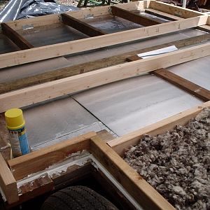 A view of some of the levels of insulation.  plywood, 2 layers of rigid foam, 4 to 6 inches of wool insulation.  I wanna be warm!