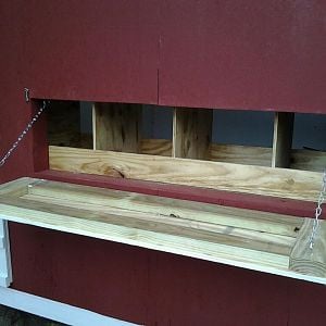 Egg door with additional back lip added to keep in eggs and bedding.