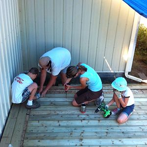 The kids and I finishing the floor boards so we can get going on the walls