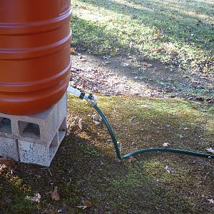 This is the water barrel.  Notice that it has a dual water spicket.  One has a hose attached that goes into the coop, the other will have a hose attached that goes into the run.  These feed water through PVC pipes in both the coop and the run providing water to the chickens via nipples.