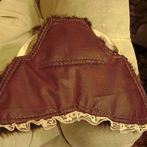The fancy saddle i made for cocoa!  Peach ribbons and lace, a rusty pleather outer and smoky blue stitching......