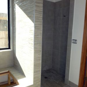 A shower and tub deck in a custom home.
