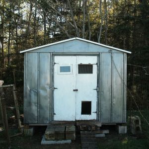 Old metal 4x8 shed I salvaged, painted, put wooden doors on, insulated and converted into chicken coop. Still a work in progress. It was basically a box kite when I drug it home.