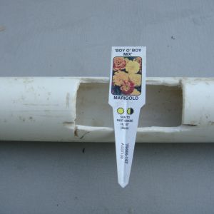 Garden tag for size comparison. We cut a hole about every twenty inches.