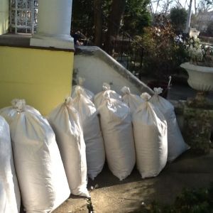 22 bags of shavings in the walkway viewed towards the front steps of the house