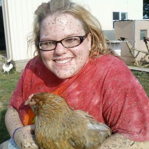 me after muddin in my four wheeler with my adorable ameraucana hen, Sweetheart