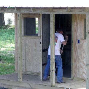 The front door has been set and widows are closed in with wire.