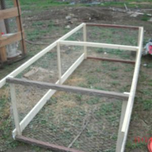 frame covered in chicken wire. you can see that the top is 1' longer than the bottom. these handles will making moving it easier,
