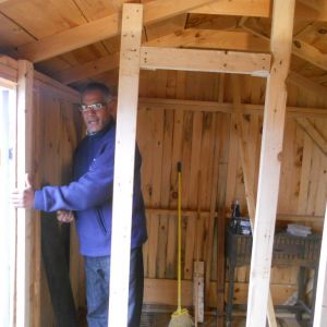 My brother helping set up where one of the interior cages for my reds will be.