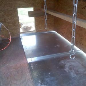 Inside of coop~ "poop drawer"