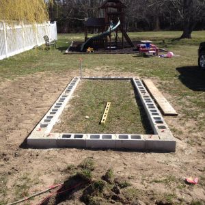 Finished foundation with dry set concrete anchor bolts and 4' x 3/8 rebar driven in all filled holes.