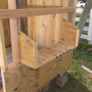 Another view of the nest box being built. I had to use very thick plywood because the plans call for the highest point of the sides to be 18". After four straight days of rain, I noticed one end of the access panel door has swollen and I will be replacing it with a piece of wood. since the height is just a little over 8". I will also be replacing the narrow strip above the access panel with wood.