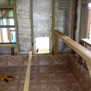 Foil insulation and linoleum tile installed