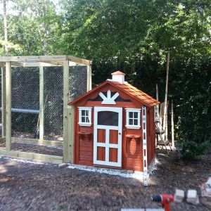 Almost done! Just have to add the door to the run, put flowers in the window "boxes", and add a river rock border around the perimeter to cover the "underground" chicken wire.