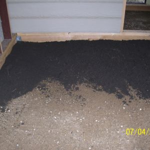 Hardware cloth over gravel and more gravel, then loam, then leaves on top.