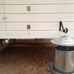 galvanized feeder with cover--close enough to the door to the run the it'll be easy to refill