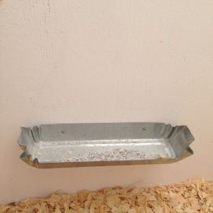 Took the lid off this floor poultry feeder & screwed it on the wall--for their grit