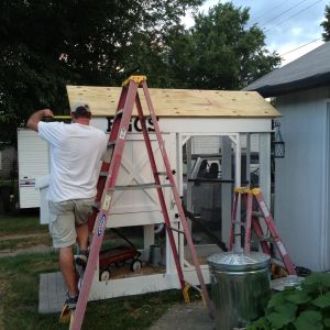 My husband making sure everything is just right- because for the love of all that is good and right in this world, he will be done with this coop someday!  (He graciously worked on this project that I started- mostly.)