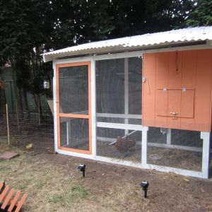 Our coop and attached run. We have nest boxes inside with an access door at the front.